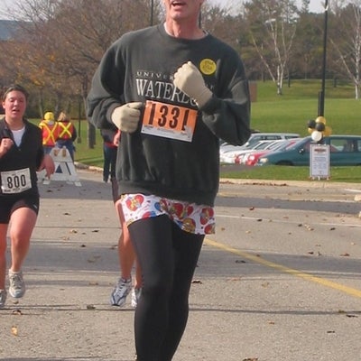 A man running wearing leggings and a skirt