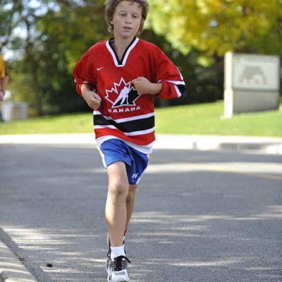 A boy in a Canada hockey shirt running