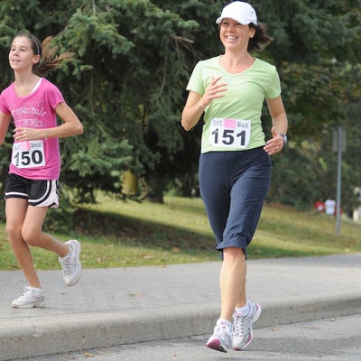 A woman and a girl running together