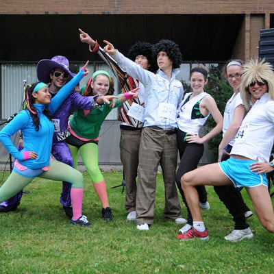 Eight people in costumes posing