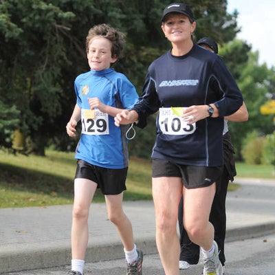 A woman and a boy running together