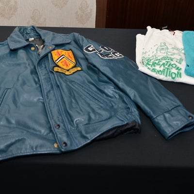 Blue leather jacket with uWaterloo logo on the left side and writing on the sleeves.