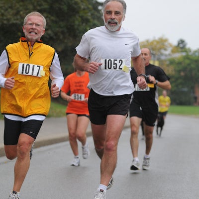 Participants running while two males in the front being focused