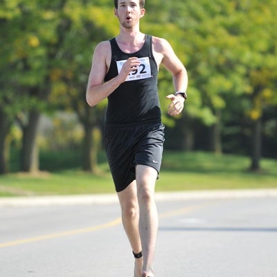 A man running barefoot
