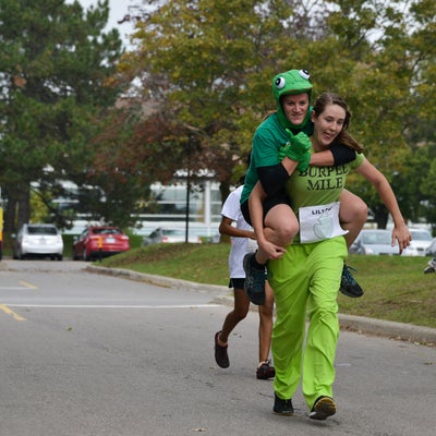 One student carrying another student on her back.