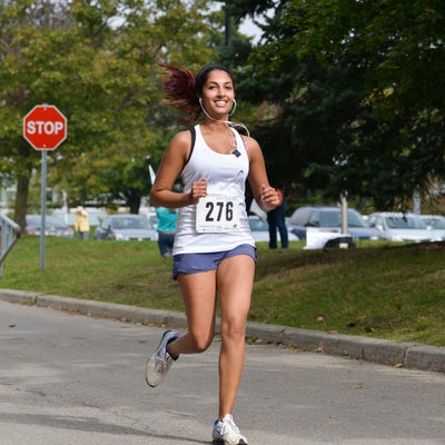 Student running and smiling.