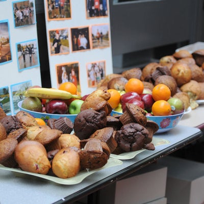 Various muffins and fruits on a table with a Fun Run photo hand-made poster