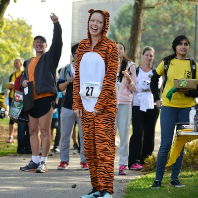 Lady wearing a tiger suit with participants in the background.
