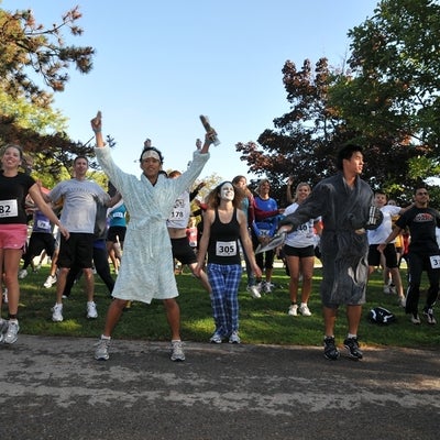 Participants in various costumes warming up before the race