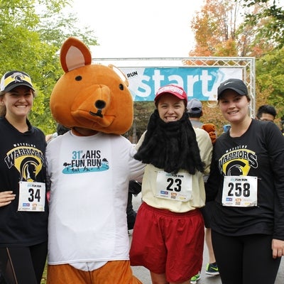 Participants standing with AHSSIE the mascot