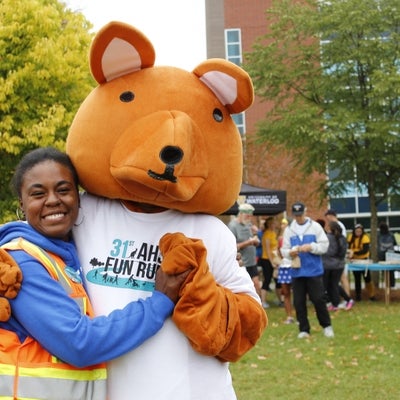 AHSSIE the mascot and a volunteer road marshal