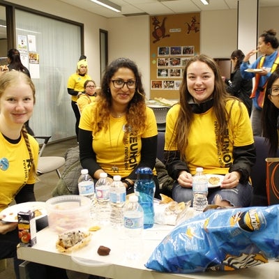 Volunteers eating lunch in the student lounge 