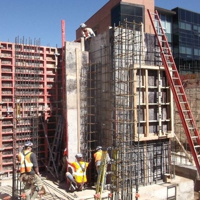 Construction workers installing formwork for the elevator.