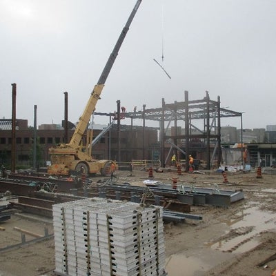 Construction workers erecting steel structure.