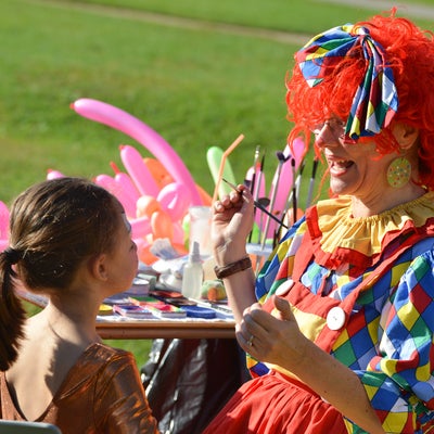 Clown painting child's face