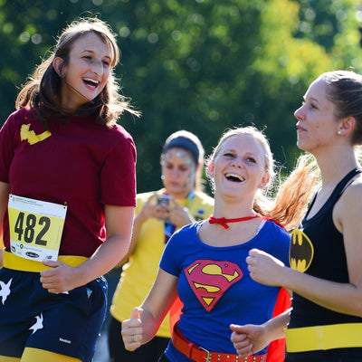 Fun Run participants dressed as super heroes waming up