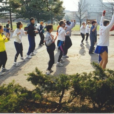 Participants stretching at a parking lot.