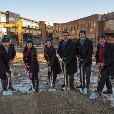 James Rush, Feridun Hamdullahpur, Ian Orchard and student representatives, wearing their AHS toques, with shovels in the ground.