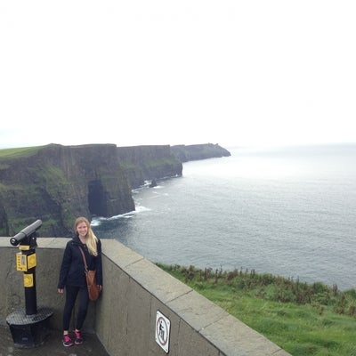 Tess standing near a cliff