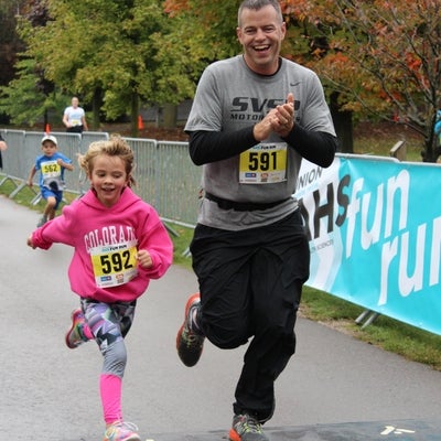Father and daughter crossing the finish line 
