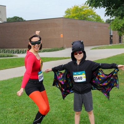 Incredible woman costume posing with kid batman costume