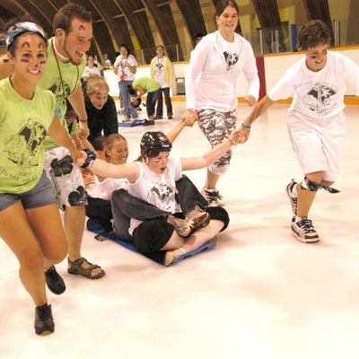 student pulling another student across ice