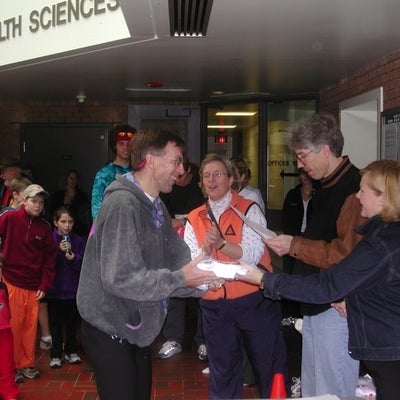 Male runner receiving a prize after the race during meeting