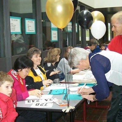Male and female signing up for the race at the registrar's desk