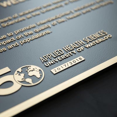 Detail of the 50th anniversary logo on the plaque