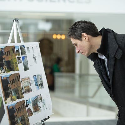 Person looking at the courtyard drawings
