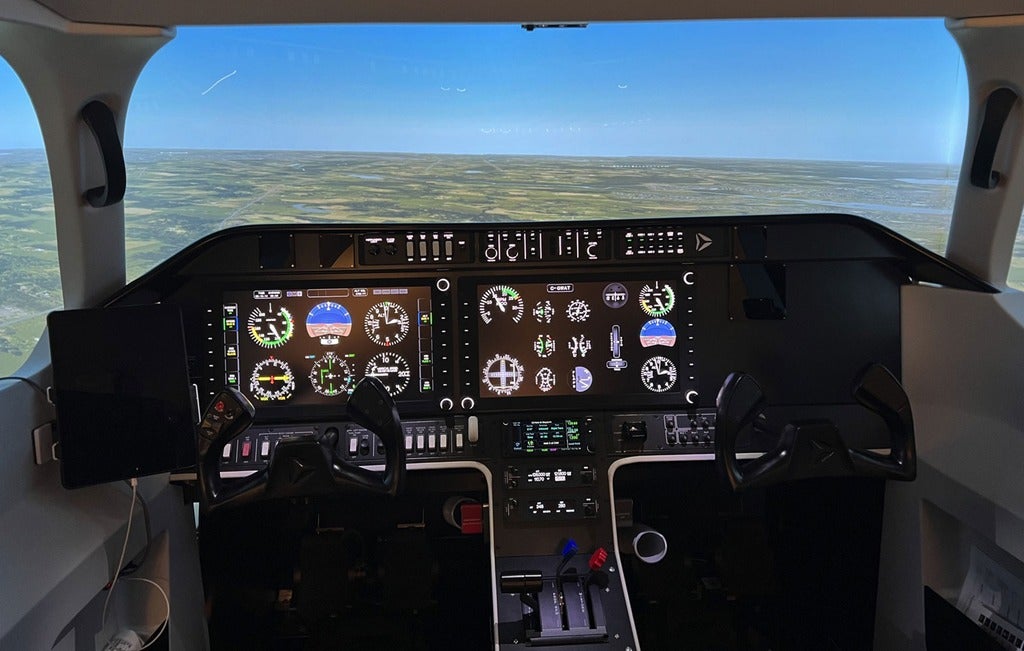 Pilot's view of plane's instrument panel and windshield  in a flight simulator.