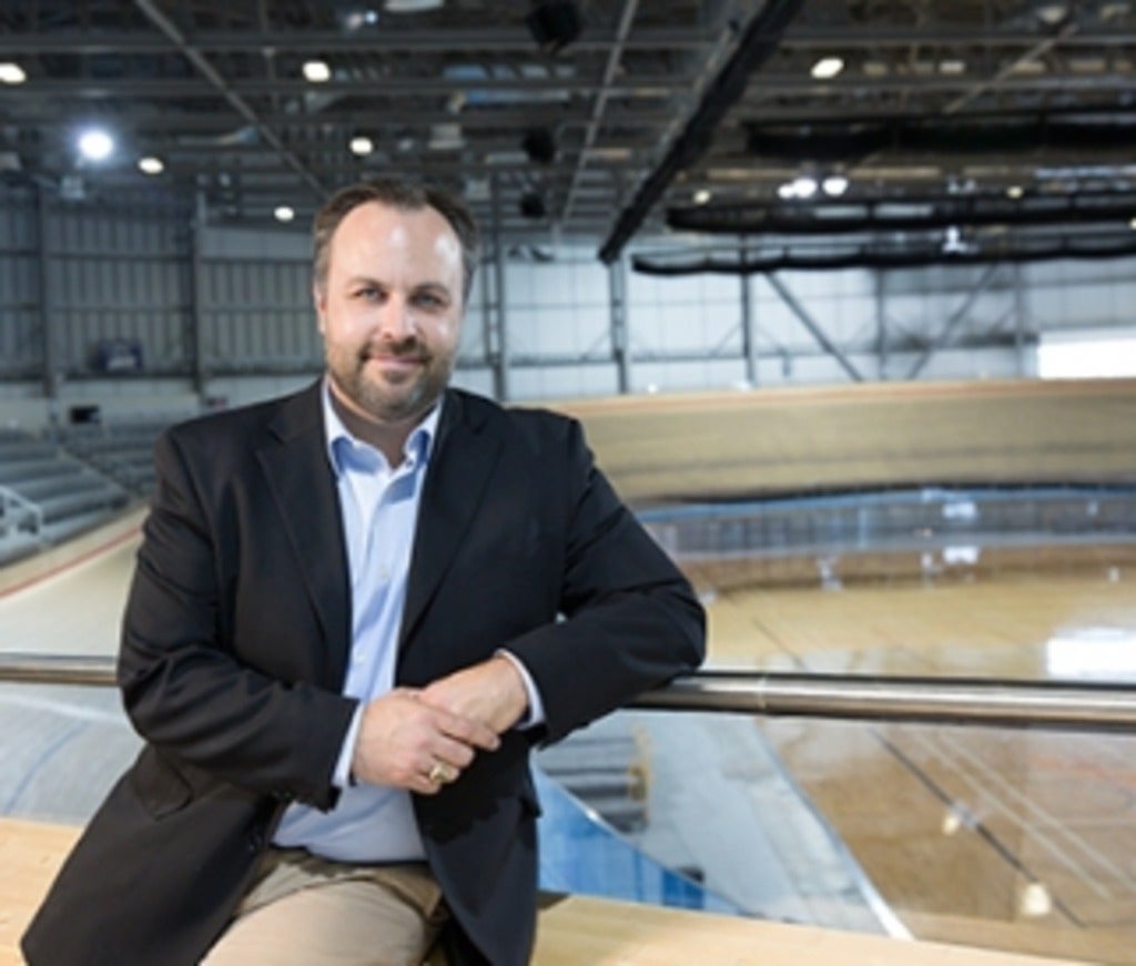 Luke Potwarka in front of velodrome cycling track.