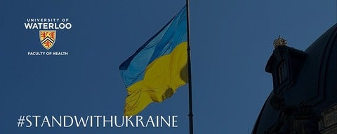 Ukranian Flag flying with hashtag #STANDWITHUKRAINE.