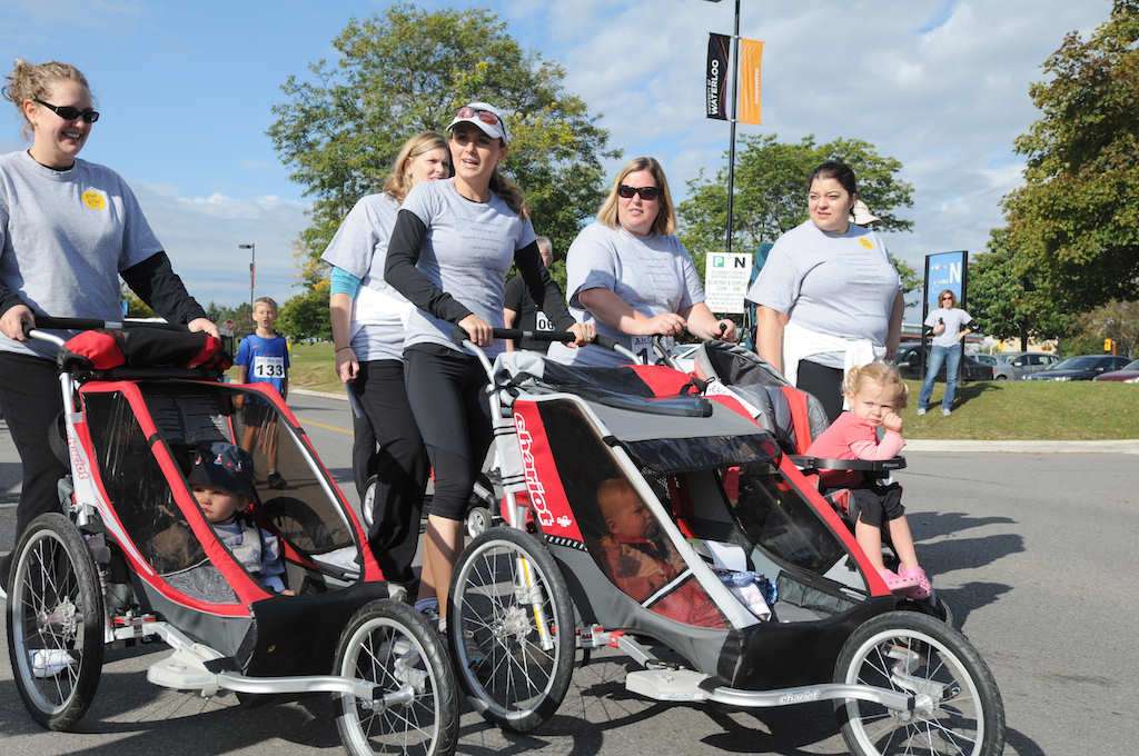 Female runners with their babies in baby strollers