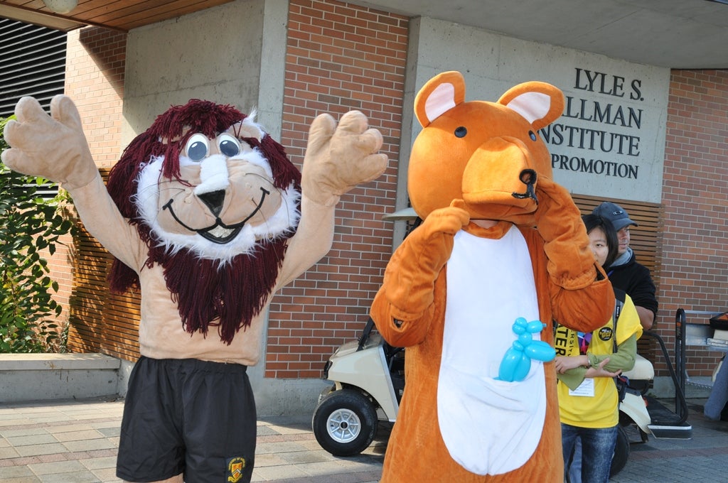 A lion mascot standing beside a bear mascot