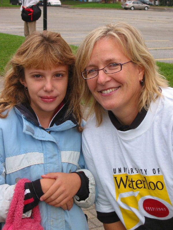 A woman with University of Waterloo t-shirt beside a girl 