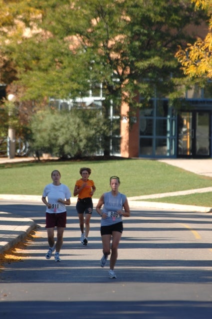 Three female runners running 