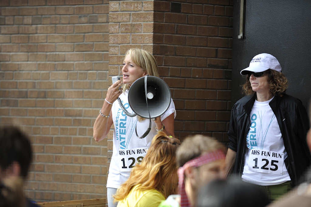 A woman holding a megaphone talking to the crowd