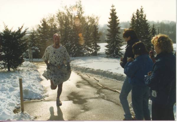 A man wearing a dress approaching to the finish line