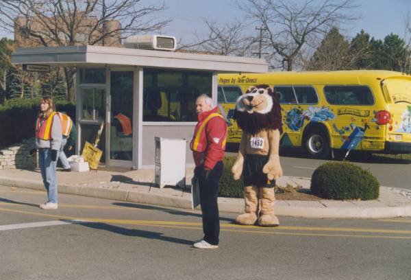 A lion mascot and two staffs.