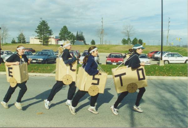 Four girls in train costume designed with four boxes attatched with strings