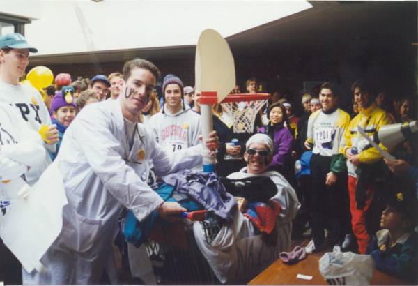 Two participants in doctor and patient costume surrounded by other participants
