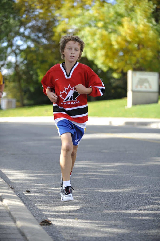 A boy in a Canada hockey shirt running