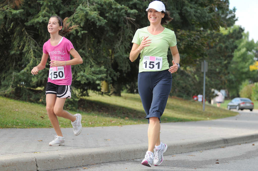 A woman and a girl running together