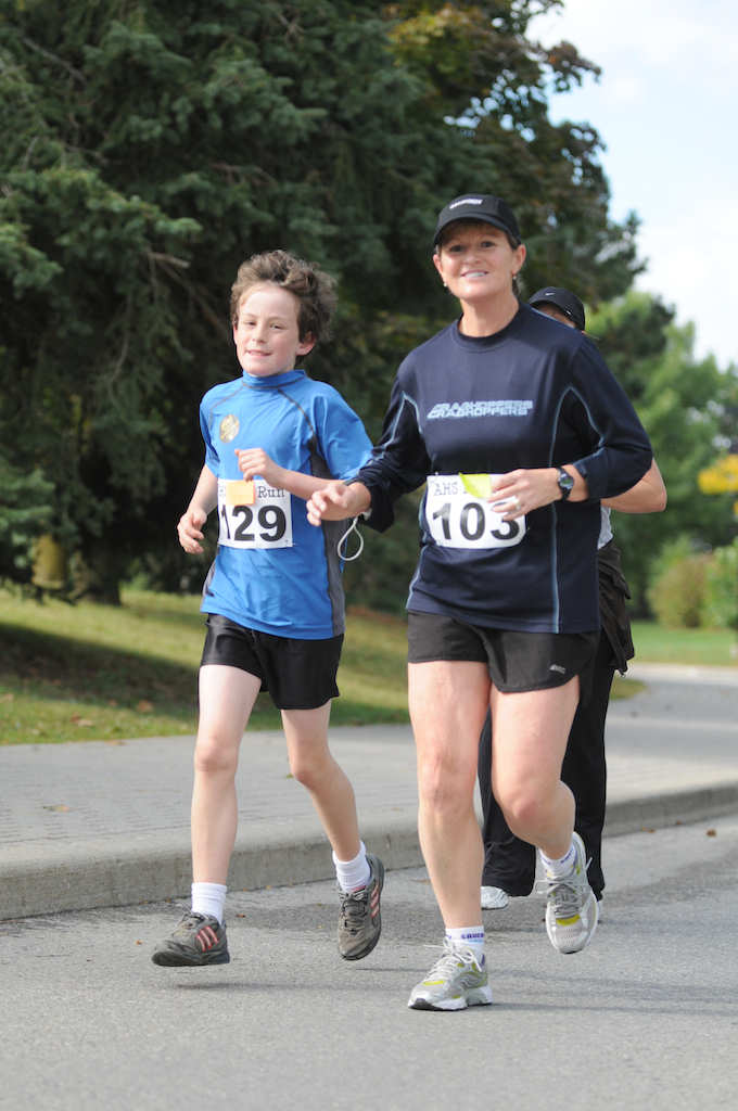 A woman and a boy running together