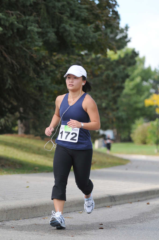 A female participant running while listening to music through earphones