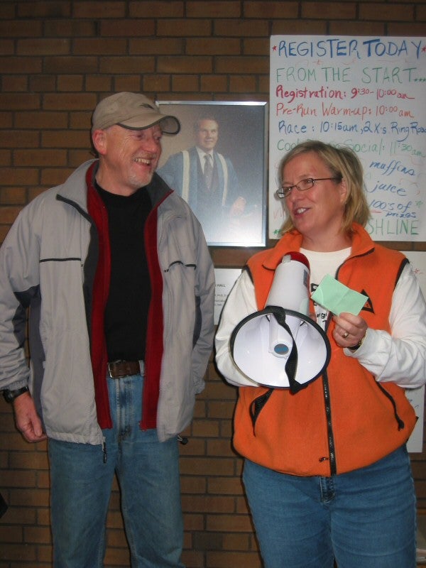 A man is talking to a woman holding a megaphone