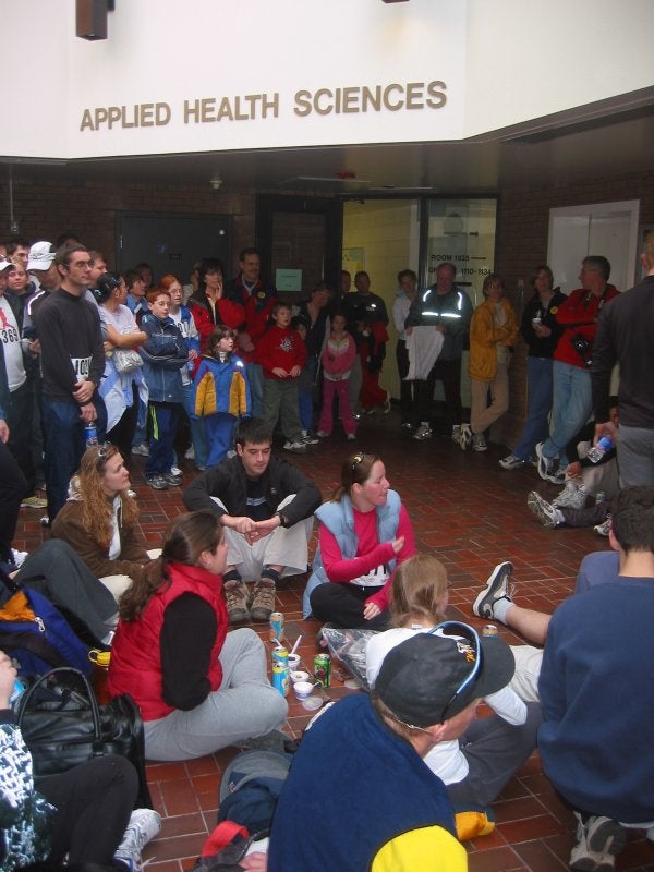 A crowd sitting and standing at Applied Health Sciences building