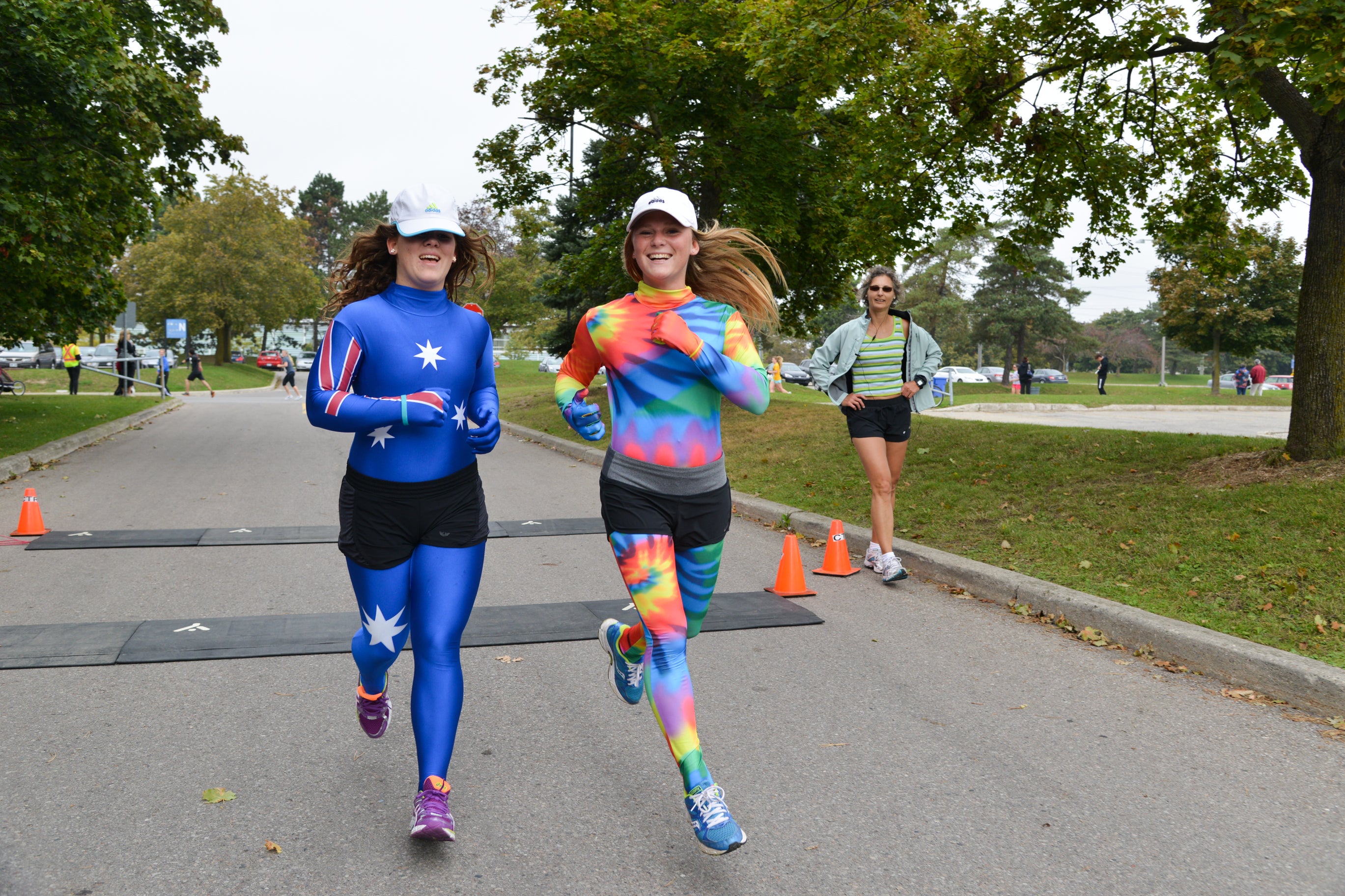Two ladies running in full body suits.