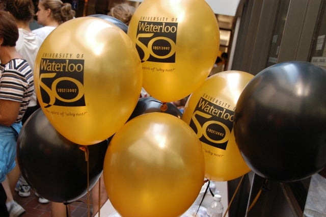 Gold and black balloons written "University of Waterloo 50"